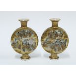 A pair of Japanese Satsuma flasks, painted with figures, signed (2) 12cm.