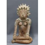 South American clay pottery figure, modelled seated in cross leg pose, 39cm