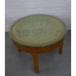 Centre table with a circular glass top with etched fish pattern, removable with space beneath. 59