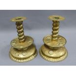 A pair of unusual brass candlesticks, with spiral stems and fruit embossed drip trays, 24cm tall (2)