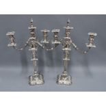 A pair of silver plate on copper candelabra, scrolling arms, flame finial and knop stemmed, 52cm