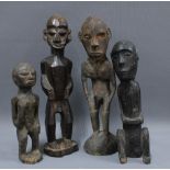 A collection of carved wooden tribal figures to include Lobi, Papa New guinea and East Africa, etc