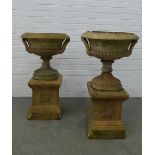 Pair of garden urns, on stands. (one is A/F) 87 x 49cm. (2)