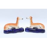 A pair of 19th century Staffordshire hound pen holders (2) 13cm.