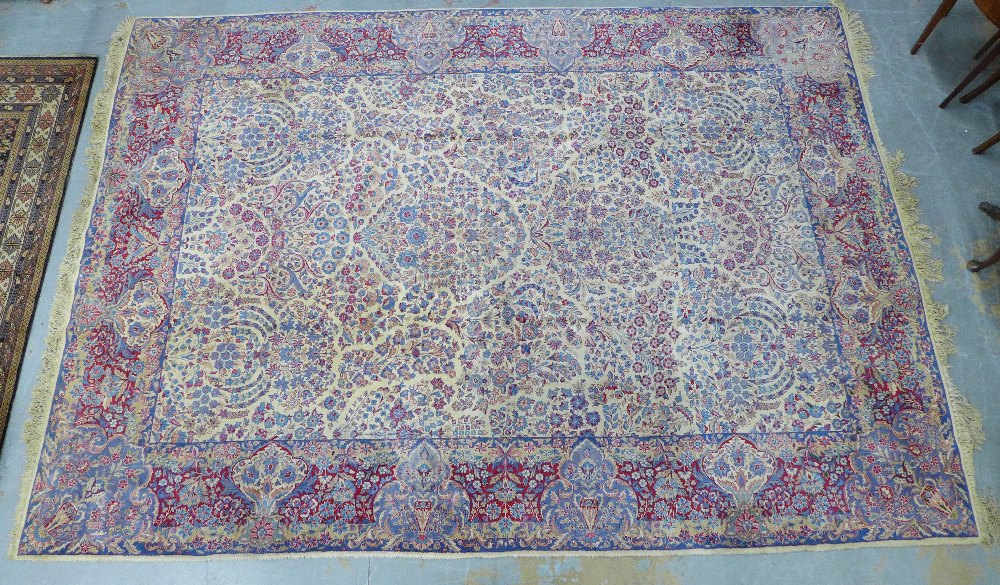 Large Indian carpet, probably Agra, ivory and pale blue field with urns and flowers design, 305 x