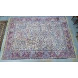 Large Indian carpet, probably Agra, ivory and pale blue field with urns and flowers design, 305 x