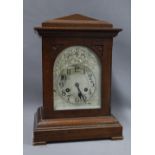 Mantle clock, mahogany case with arched top over a silvered dial with Arabic numerals, 38cm