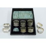 Four silver hallmarked napkin rings, and five boxed silver plate napkin rings (9)