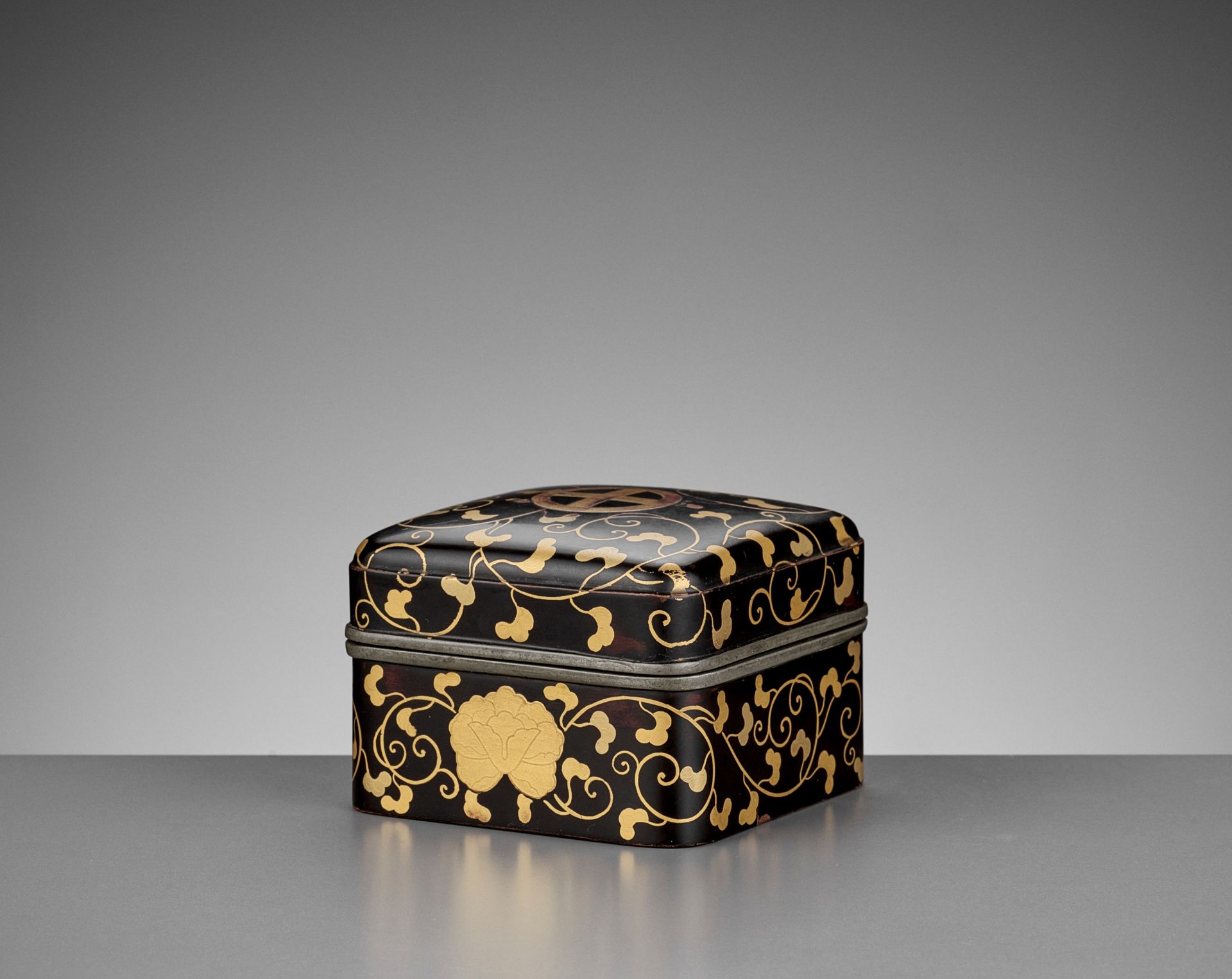 A RARE BLACK AND GOLD-LACQUERED KOBAKO AND COVER WITH SHIMAZU MONS