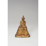 A SMALL LACQUER GILT BRONZE FIGURE OF A SEATED BUDDHA