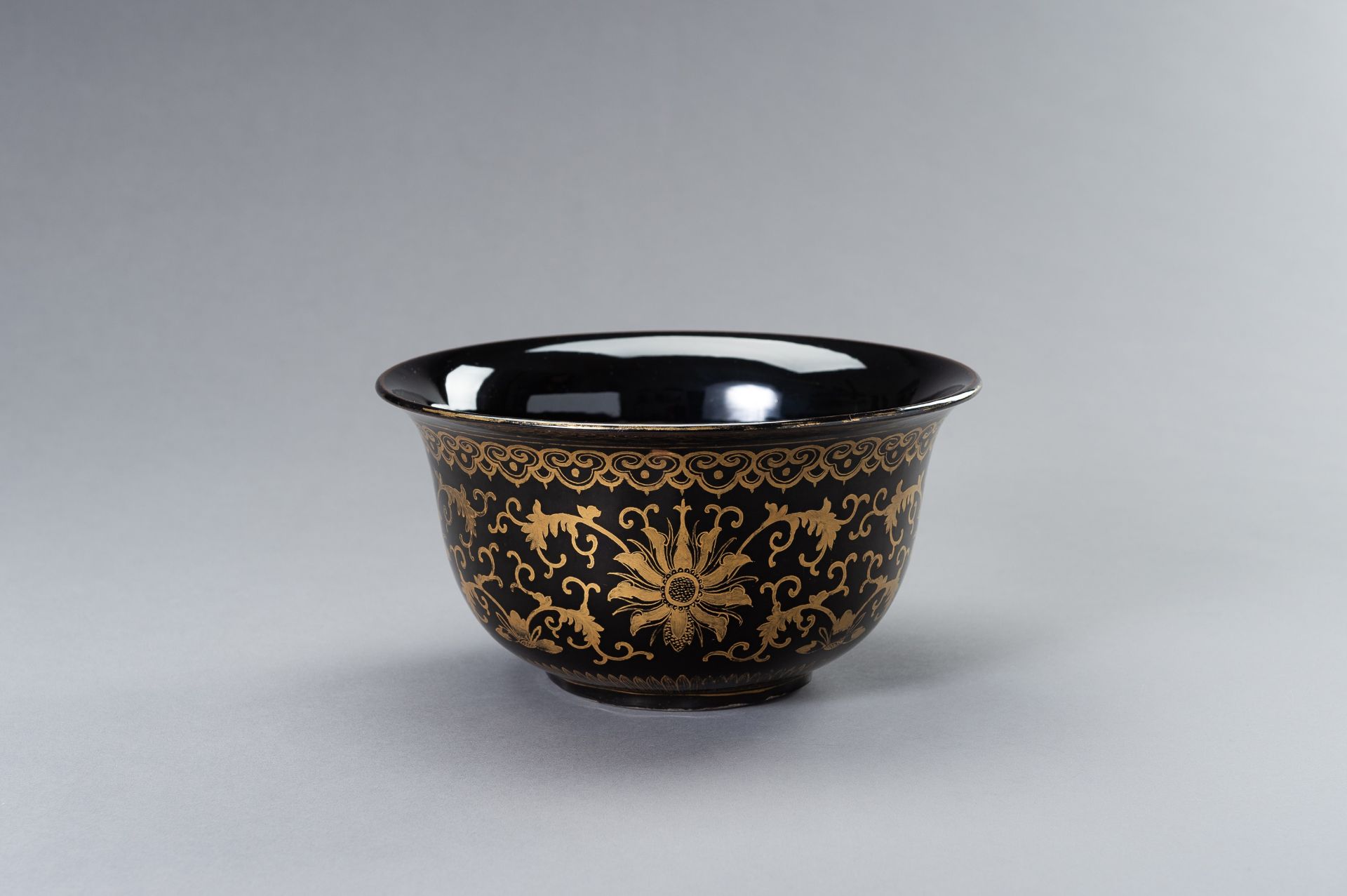 A LARGE BLACK AND GOLD PORCELAIN BOWL