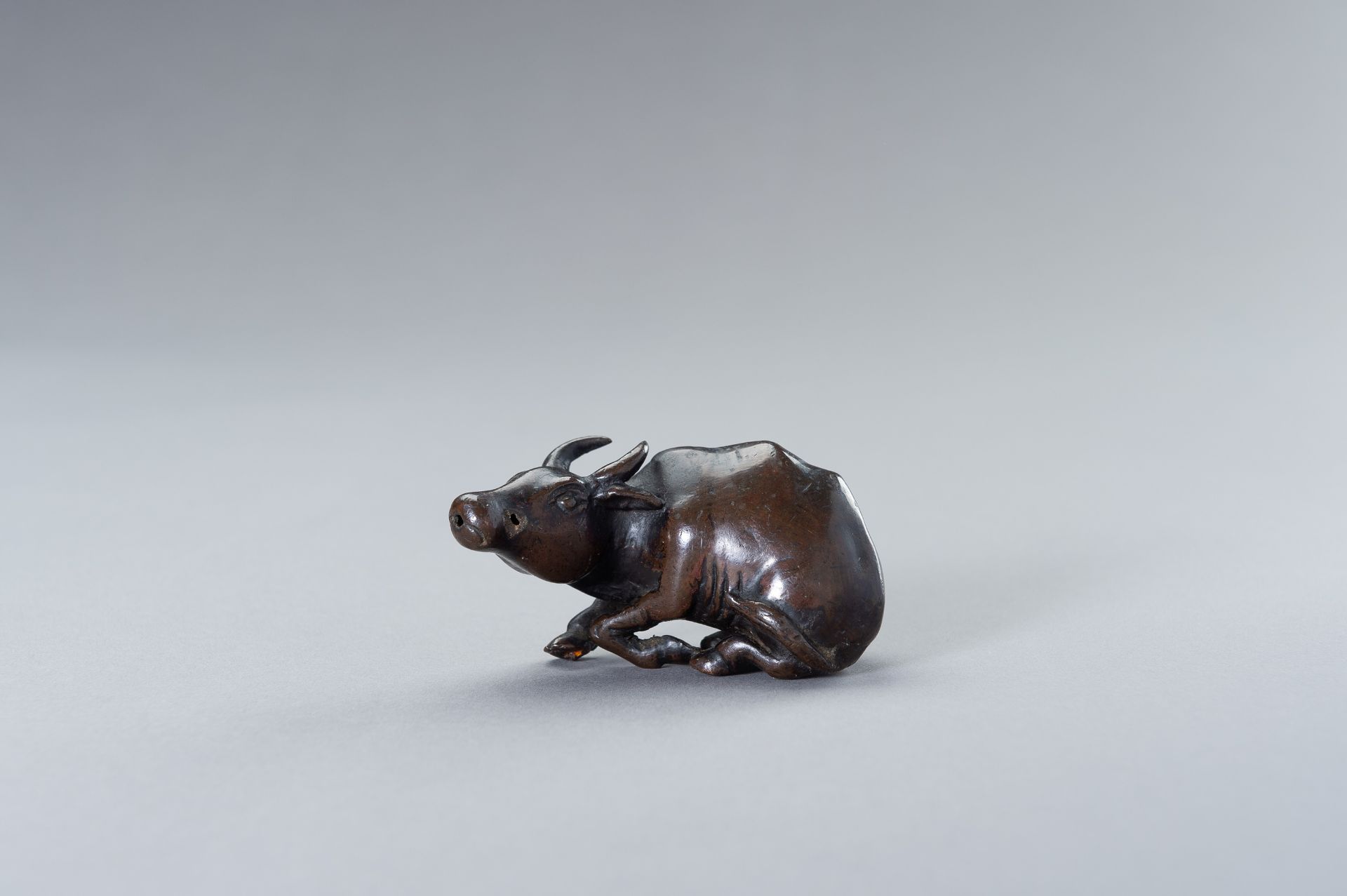 A CHINESE BRONZE FIGURE OF A WATER BUFFALO