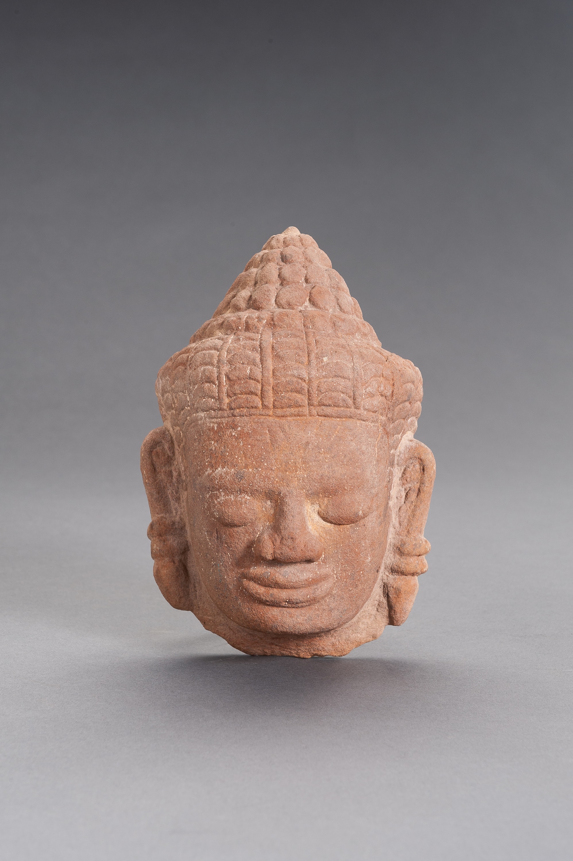 A KHMER SANDSTONE HEAD OF BUDDHA
