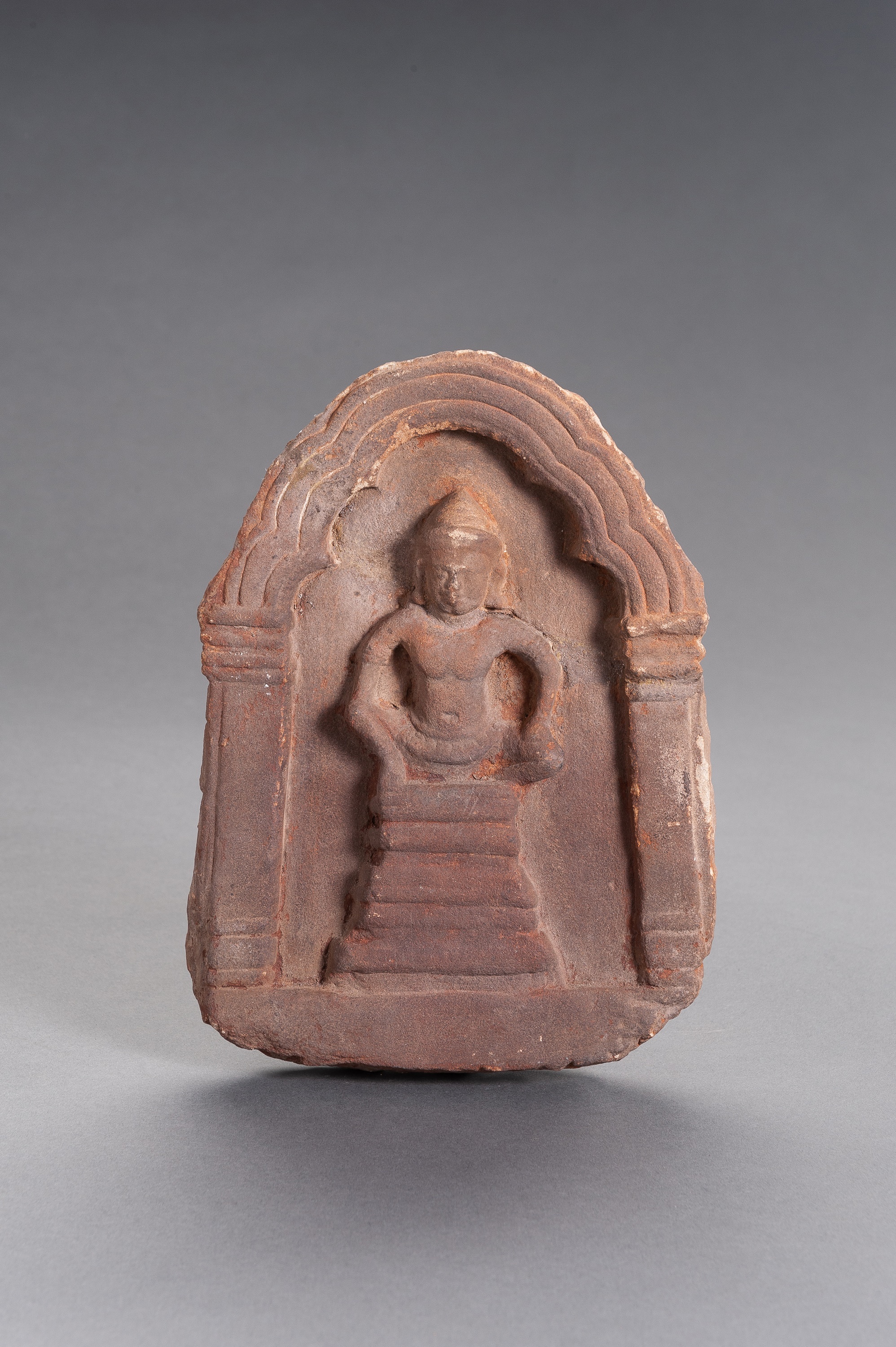A KHMER SANDSTONE VOTIVE PLAQUE OF BUDDHA