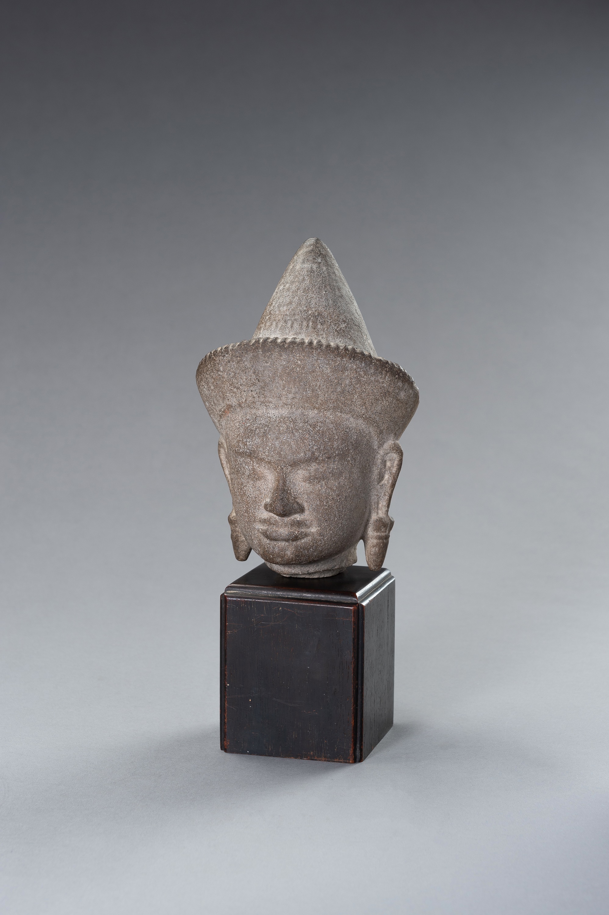 A MUSEUM COPY OF A KHMER STONE HEAD