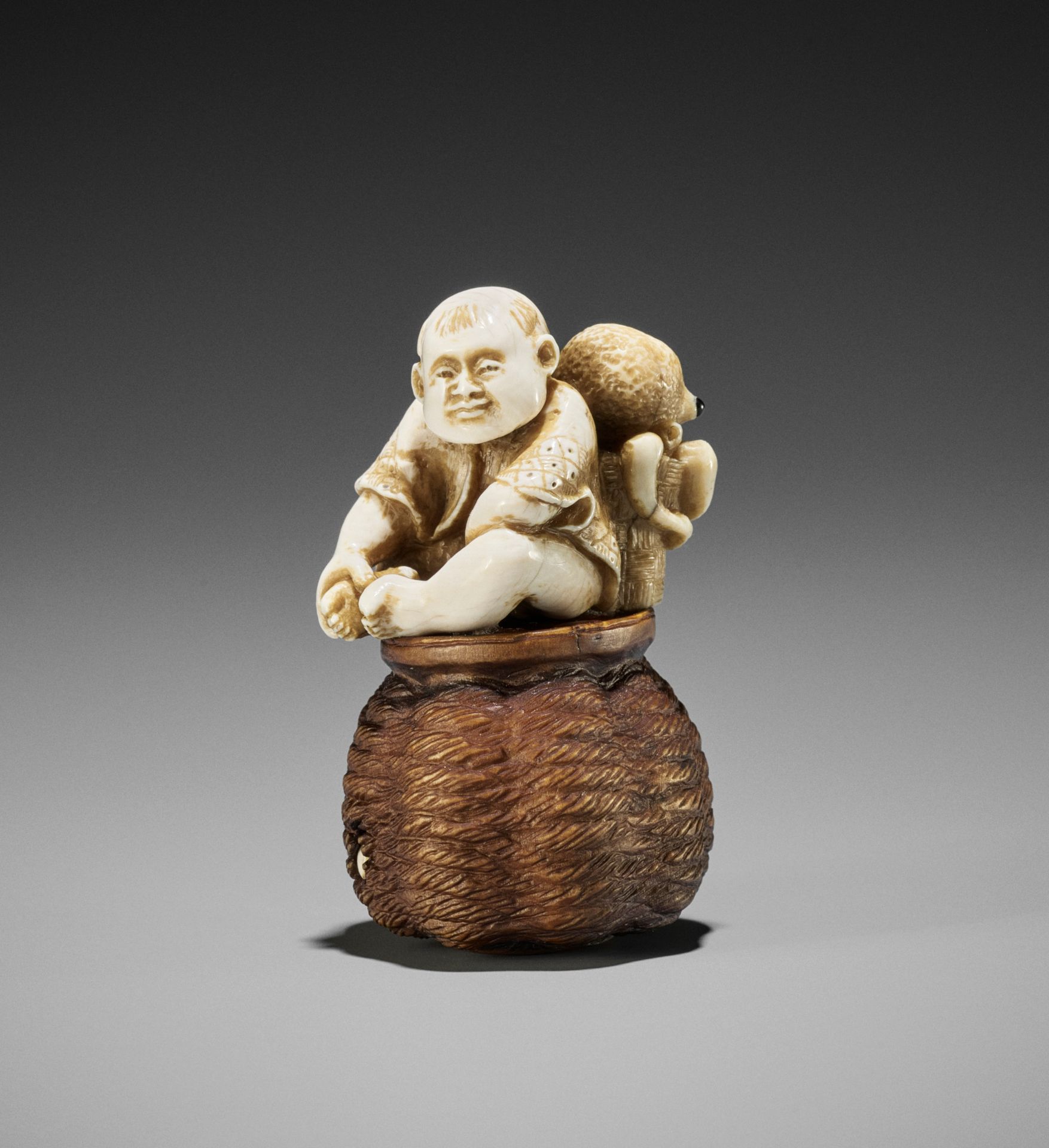 DERKACHENKO: A WOOD AND MAMMOTH IVORY SHUNGA NETSUKE OF A KARAKO WITH OCTOPUS