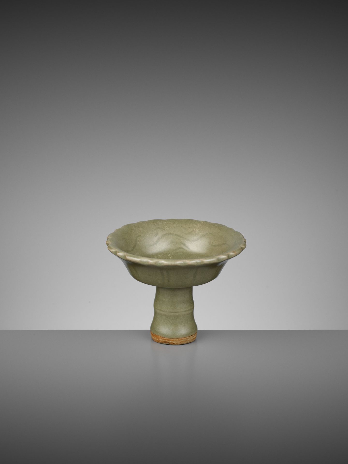 A LONGQUAN CELADON 'BAMBOO' BARBED-RIM STEM CUP, YUAN TO EARLY MING