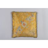 A YELLOW SILK CUSHION WITH DRAGONS
