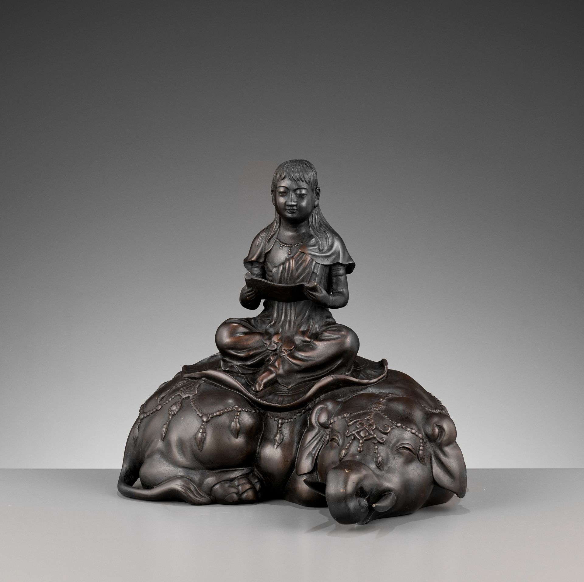 SHIUN: A FINE BRONZE OKIMONO OF FUGEN BOSATSU SEATED ON AN ELEPHANT