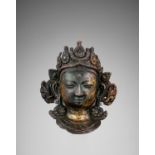 A COPPER REPOUSSE NAVADURGA MASK