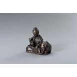 A BRONZE FIGURE OF GUANYIN WITH ELEPHANT