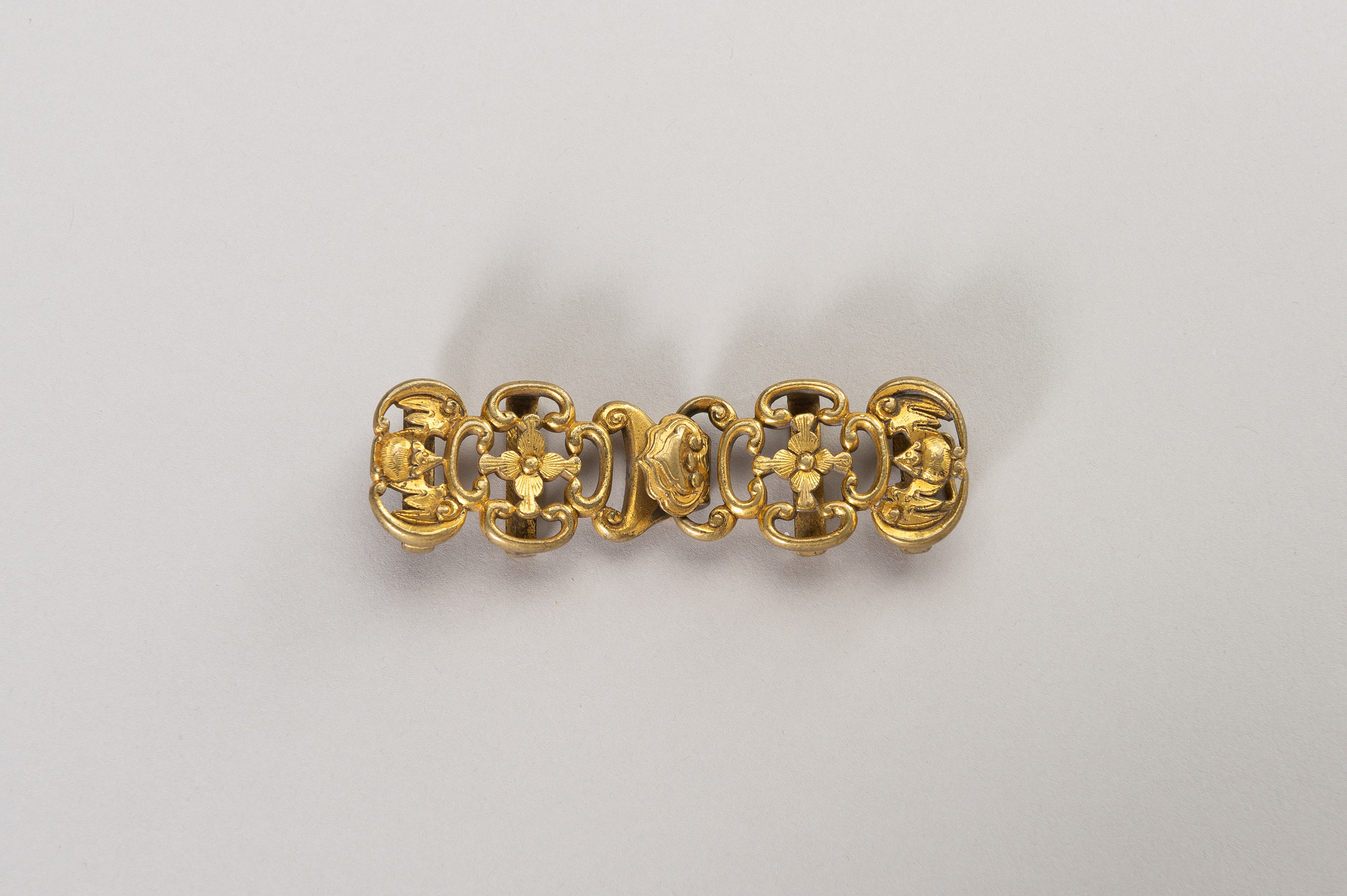 AN APPEALING GILT BRONZE BELT HOOK