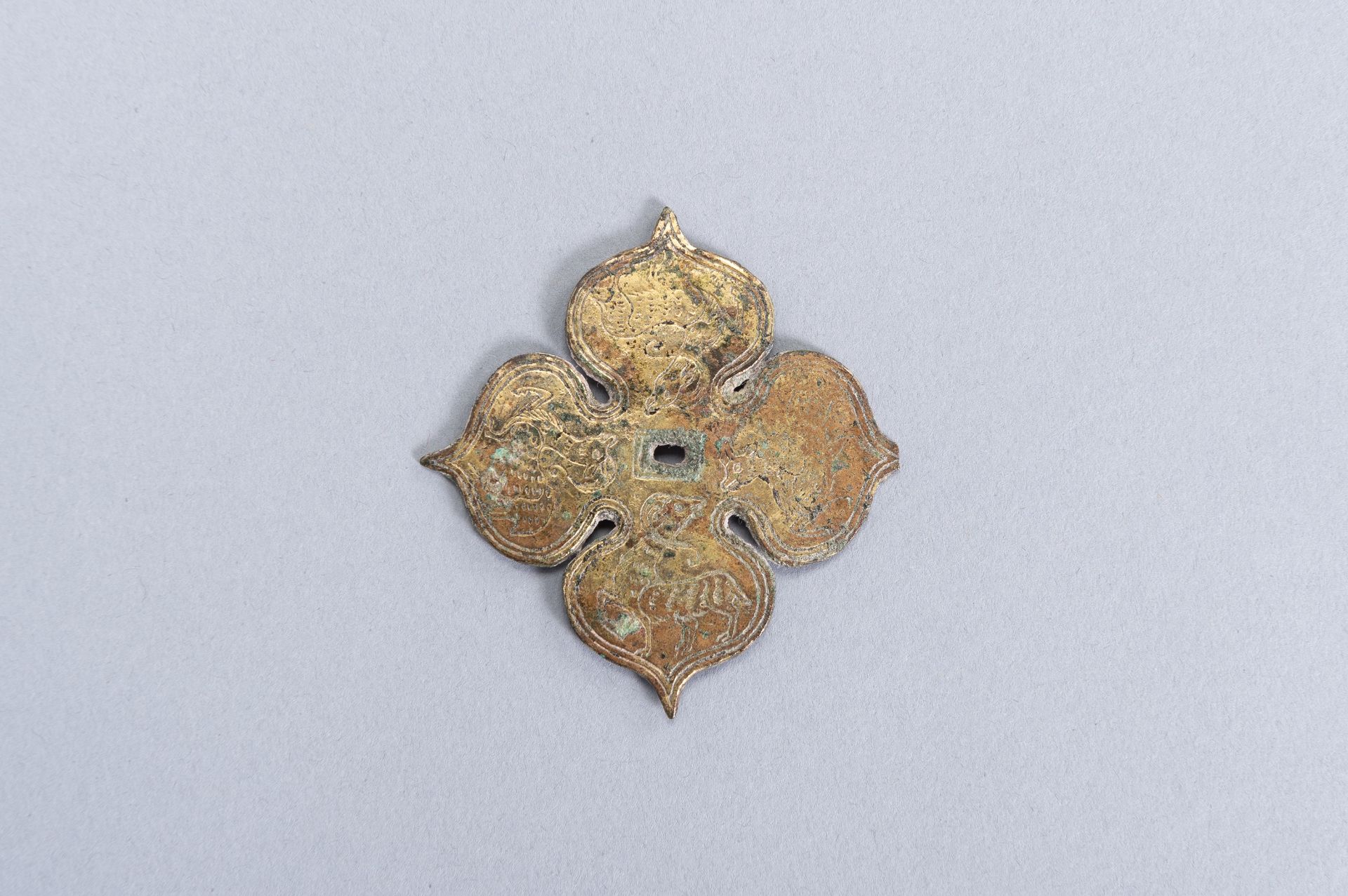 A GILT-BRONZE 'FOUR LOBED' PLAQUE, TANG DYNASTY