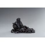 A DARK WOOD FIGURE OF BODHIDHARMA