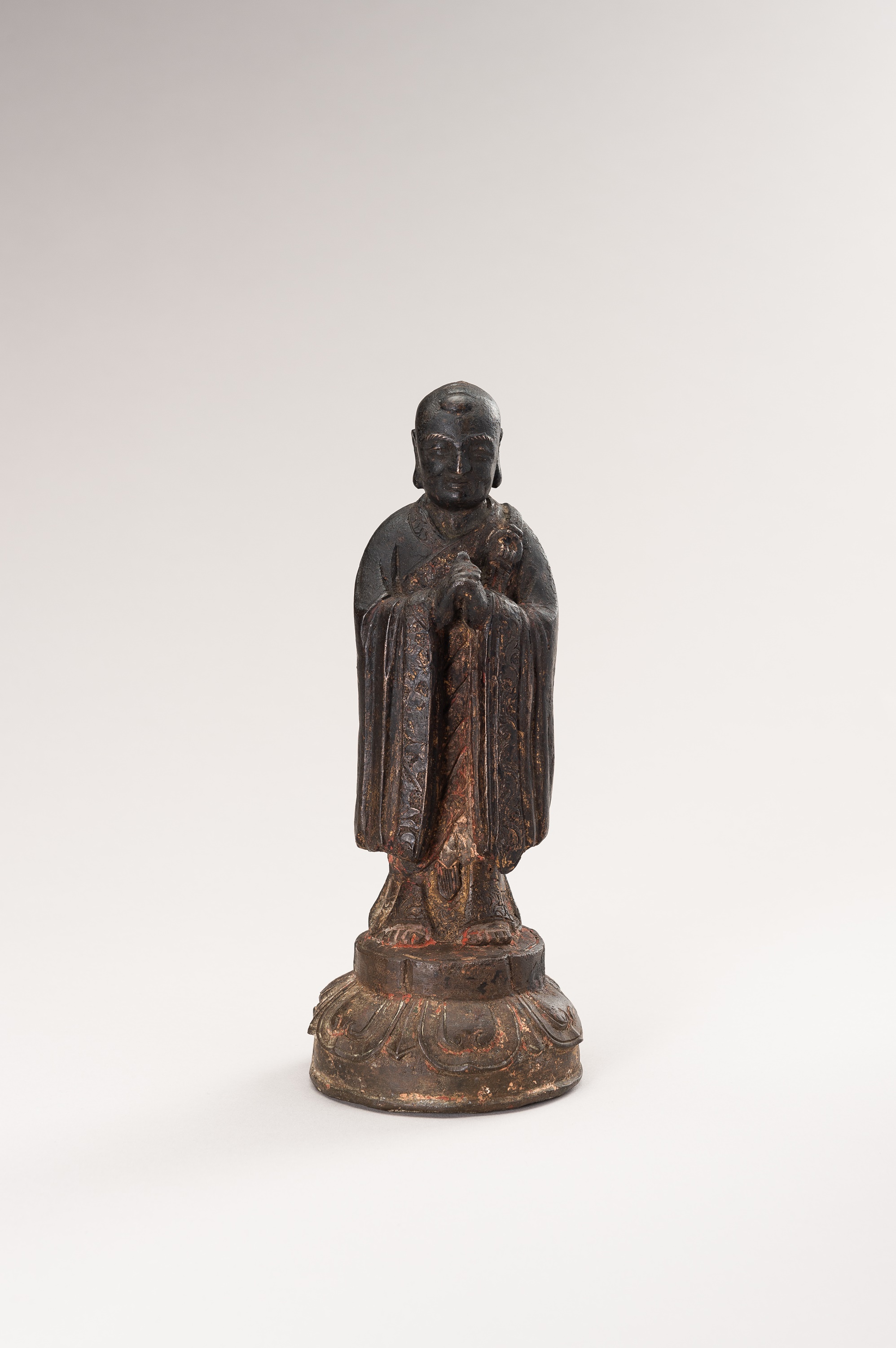 A BRONZE FIGURE OF A LUOHAN