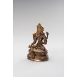 A SMALL GILT-BRONZE FIGURE OF GREEN TARA