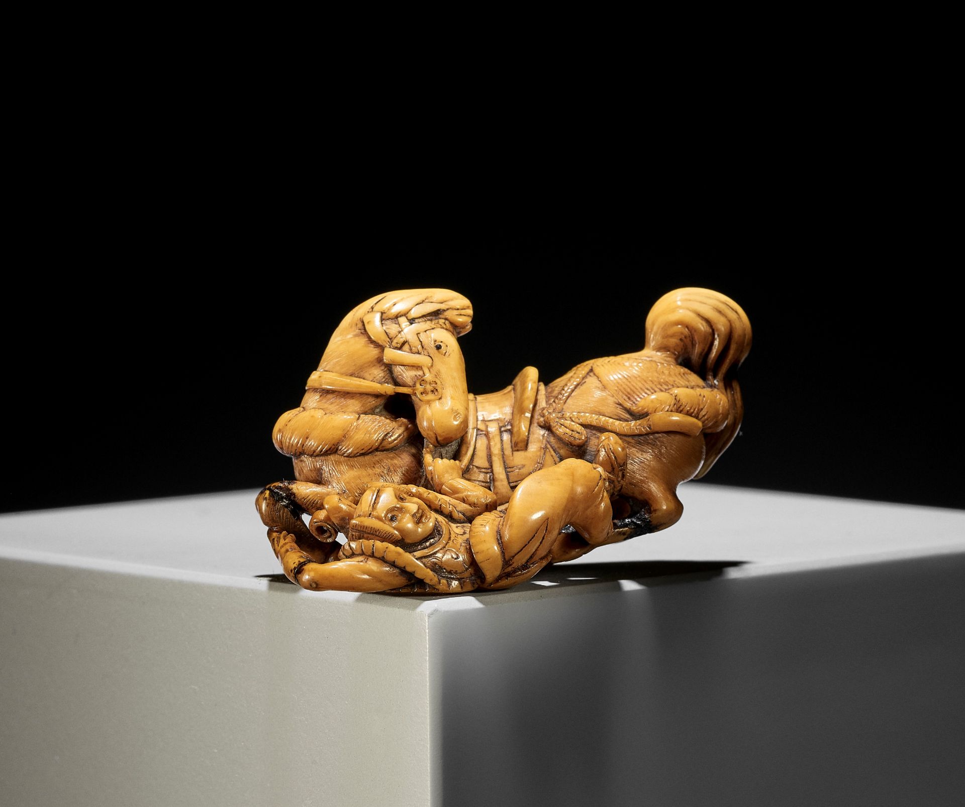 GENRYOSAI MINKOKU I: A RARE IVORY NETSUKE OF A HORSE AND GROOM