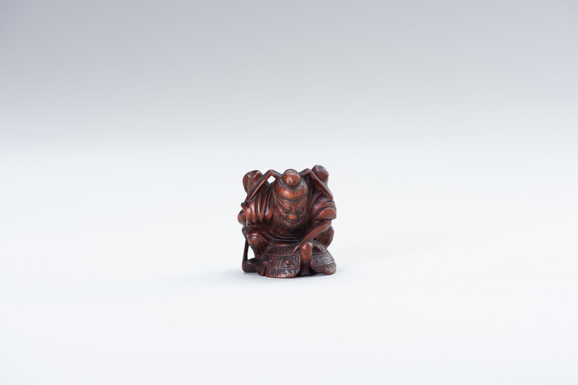 A WOOD NETSUKE OF SHOKI AND ONI