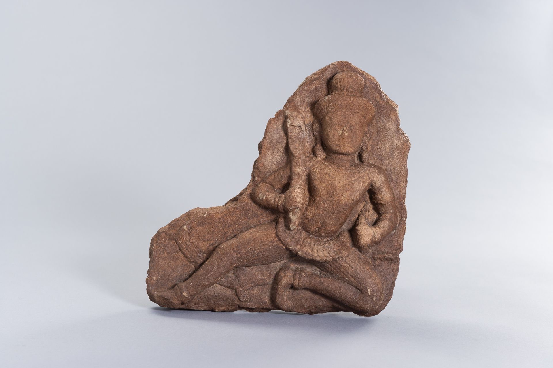 A KHMER SANDSTONE RELIEF OF A DEITY