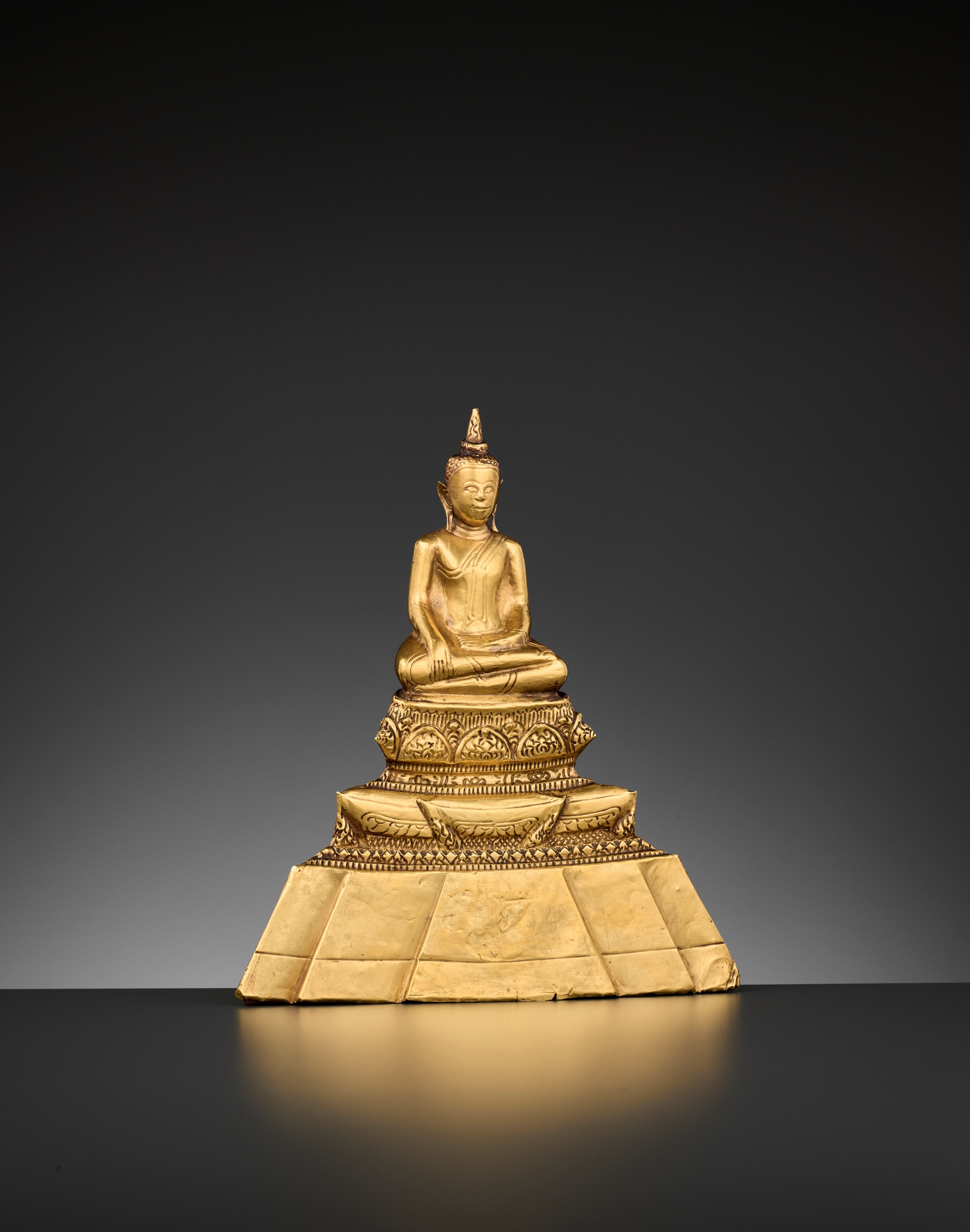 A 24-CARAT GOLD REPOUSSE FIGURE OF BUDDHA SHAKYAMUNI, AYUTTHAYA STYLE