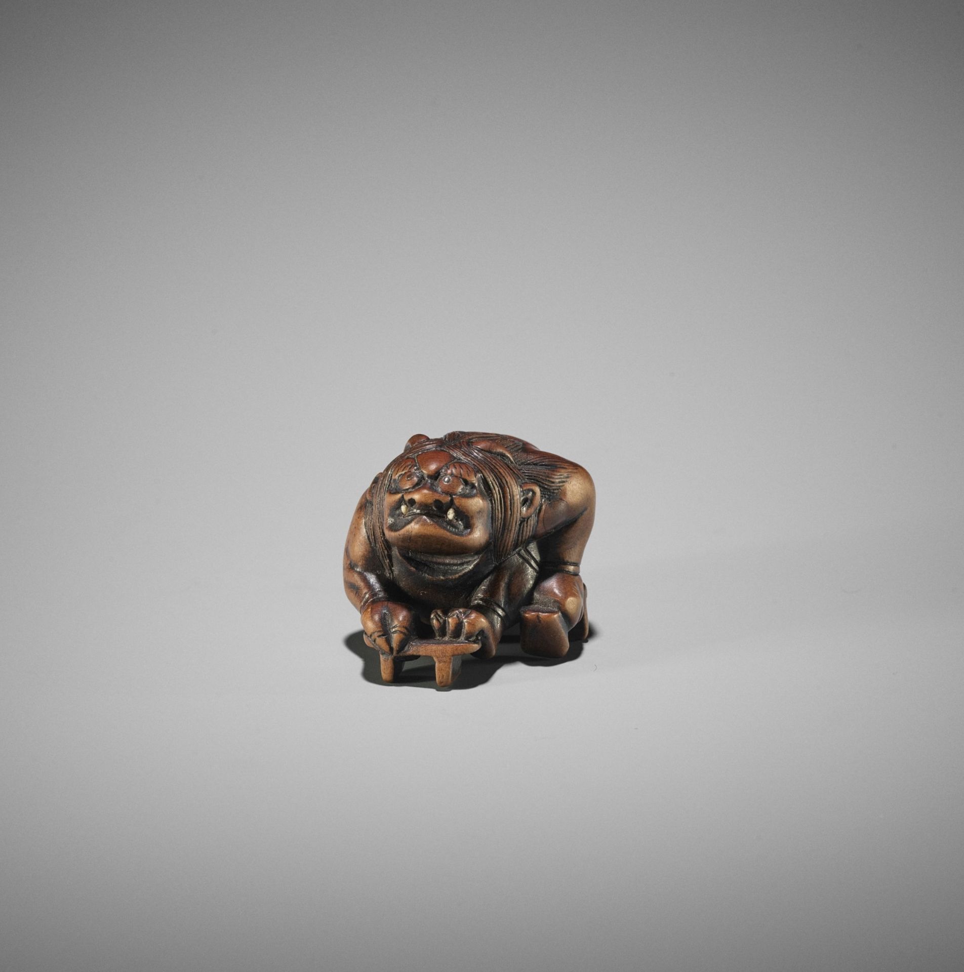 A WOOD NETSUKE OF RAIJIN WITH GETA