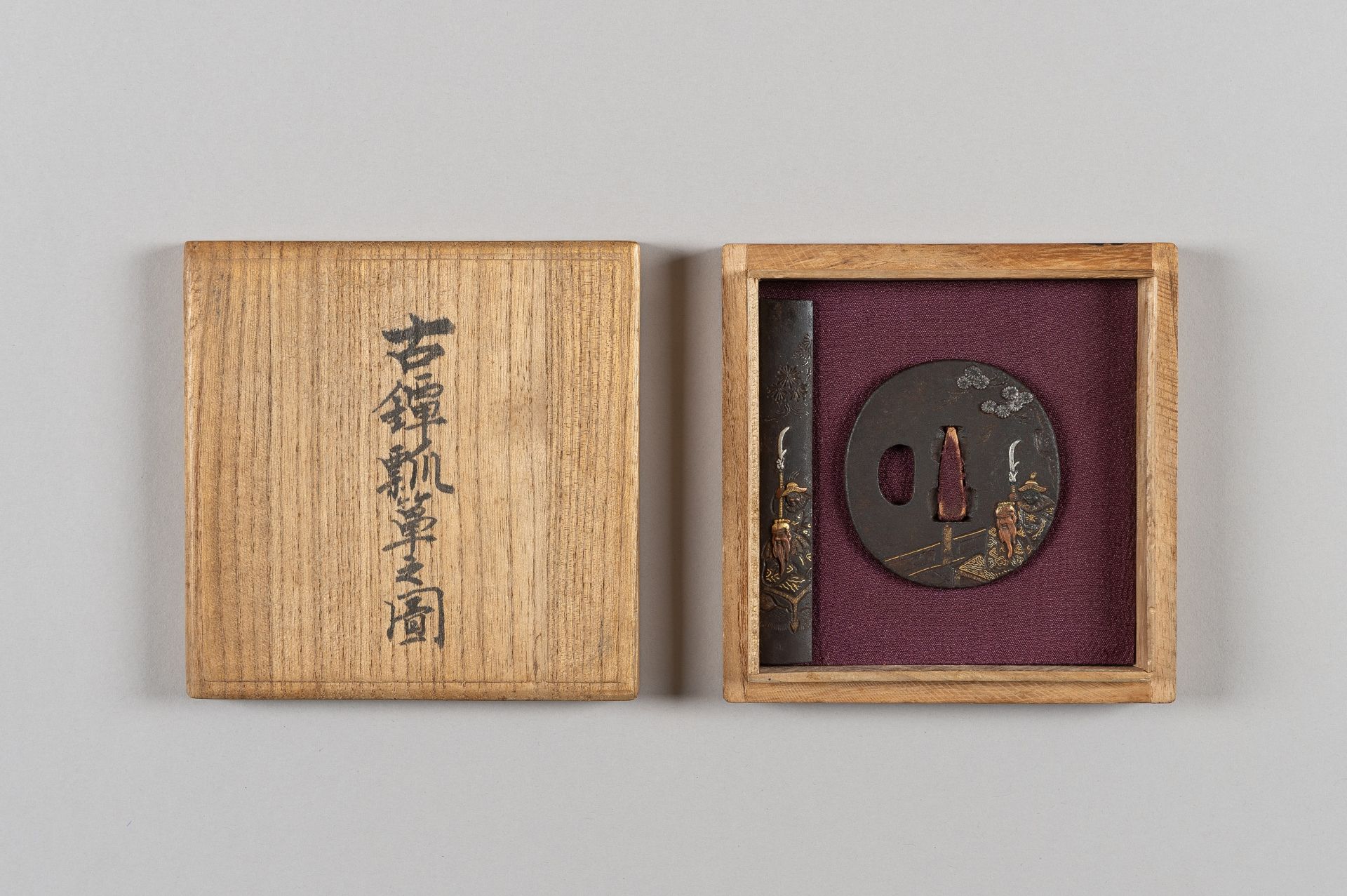 AN IRON TSUBA AND KOZUKA DEPICTING GENERAL KAN'U