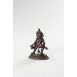 A MINIATURE COPPER ALLOY FIGURE OF KUBERA