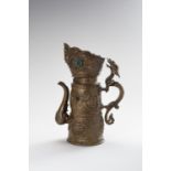 A BRASS REPOUSSE BEER EWER