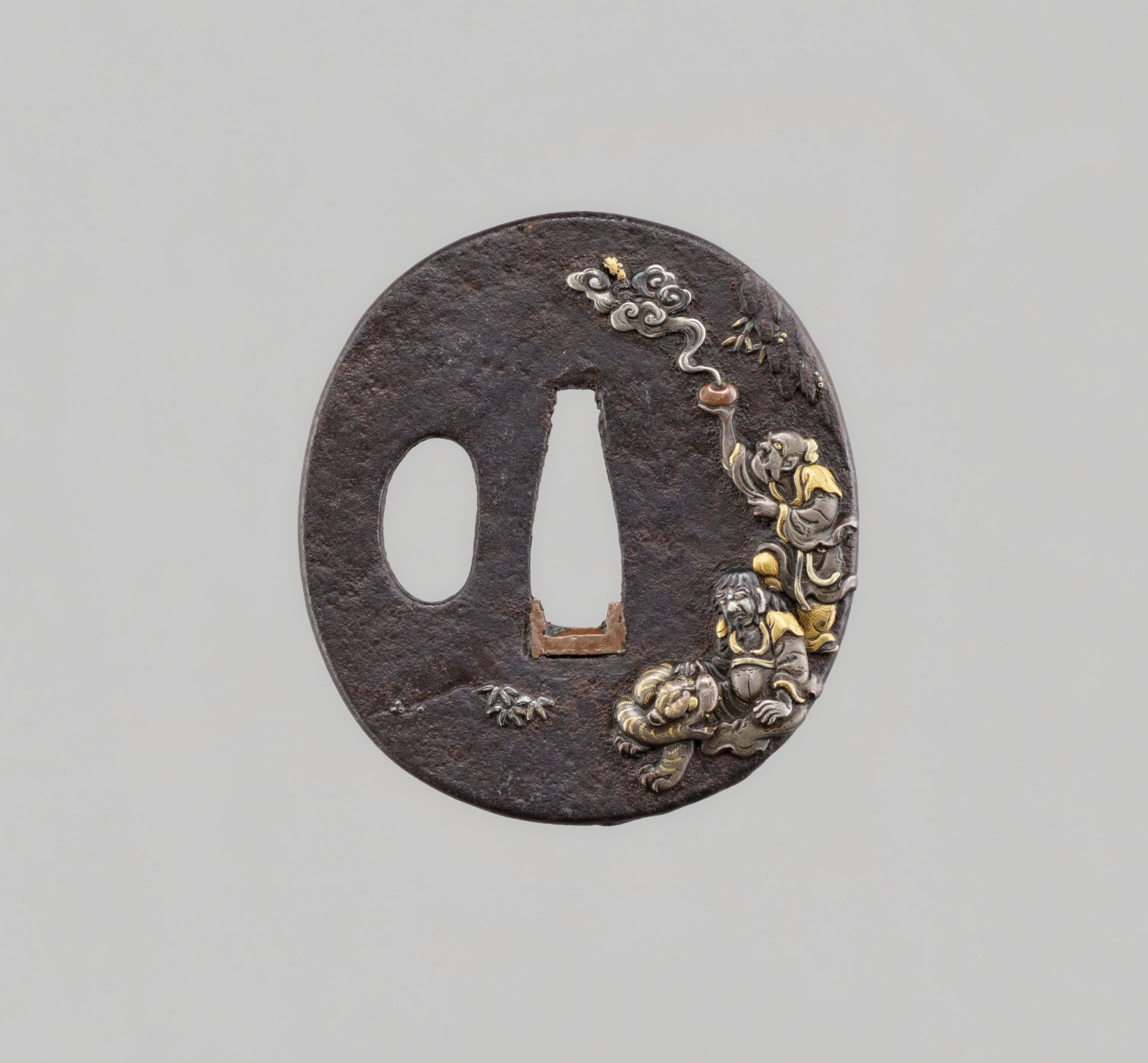 A FINE IRON TSUBA WITH CHINNAN AND TOHO SENNIN