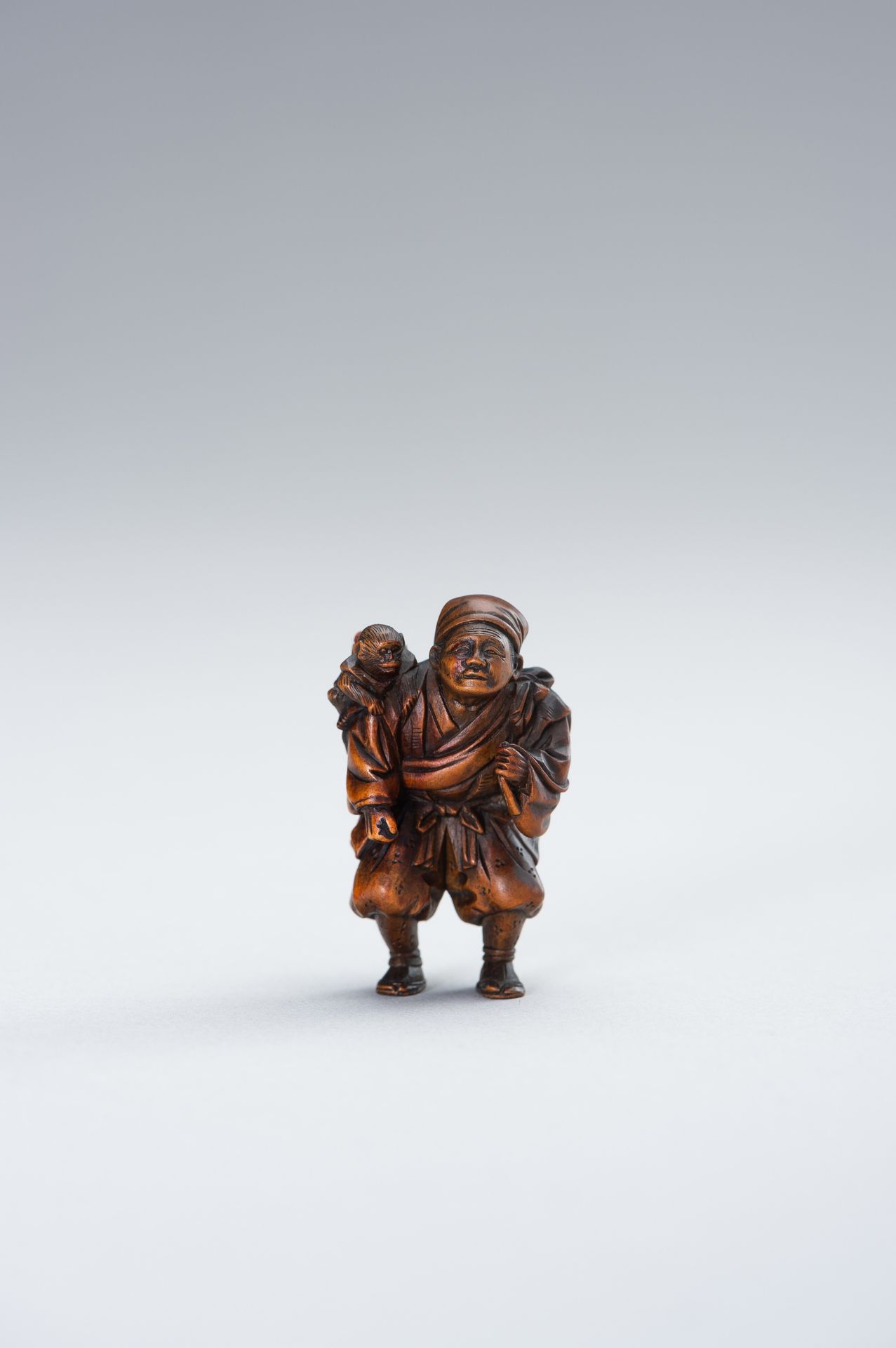 MINKOKU: A WOOD NETSUKE OF SARUMAWASHI