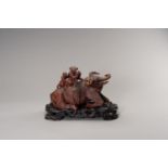 A VERY LARGE WOOD SCULPTURE OF AN IMMORTAL AND SERVANT RIDING A WATER BUFFALO