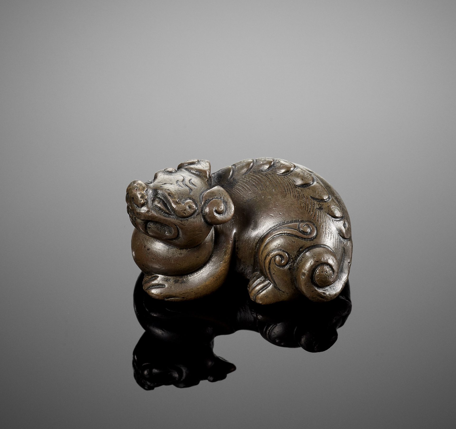 A HEAVY BRONZE 'LION' WEIGHT, MING DYNASTY