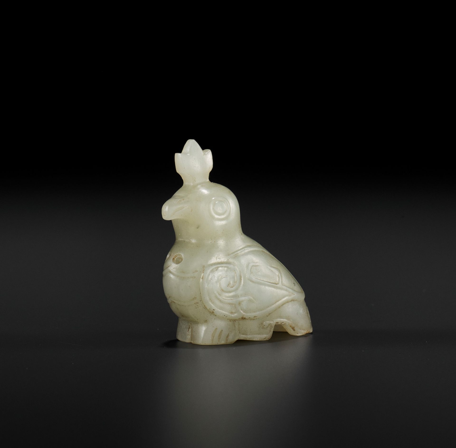 A PALE CELADON JADE CARVING OF A BIRD, WESTERN ZHOU DYNASTY