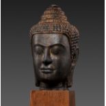 A LARGE SANDSTONE HEAD OF BUDDHA, POST-ANGKOR PERIOD