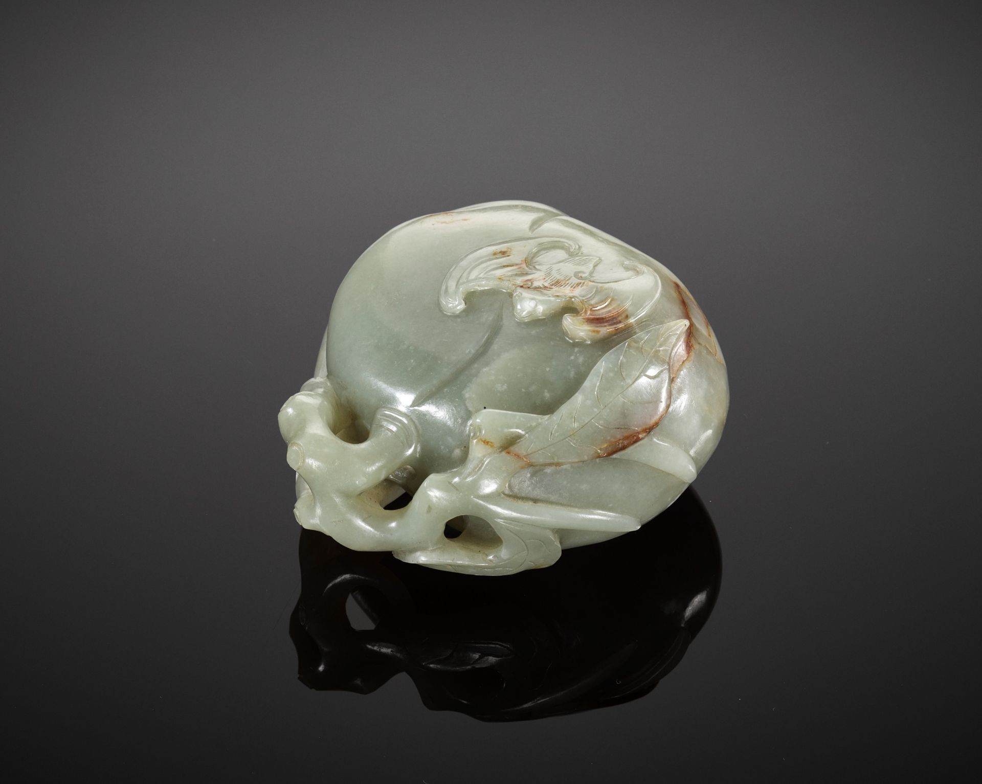 A DEEP CELADON AND RUSSET JADE 'PEACH AND BAT' GROUP, EARLY QING DYNASTY