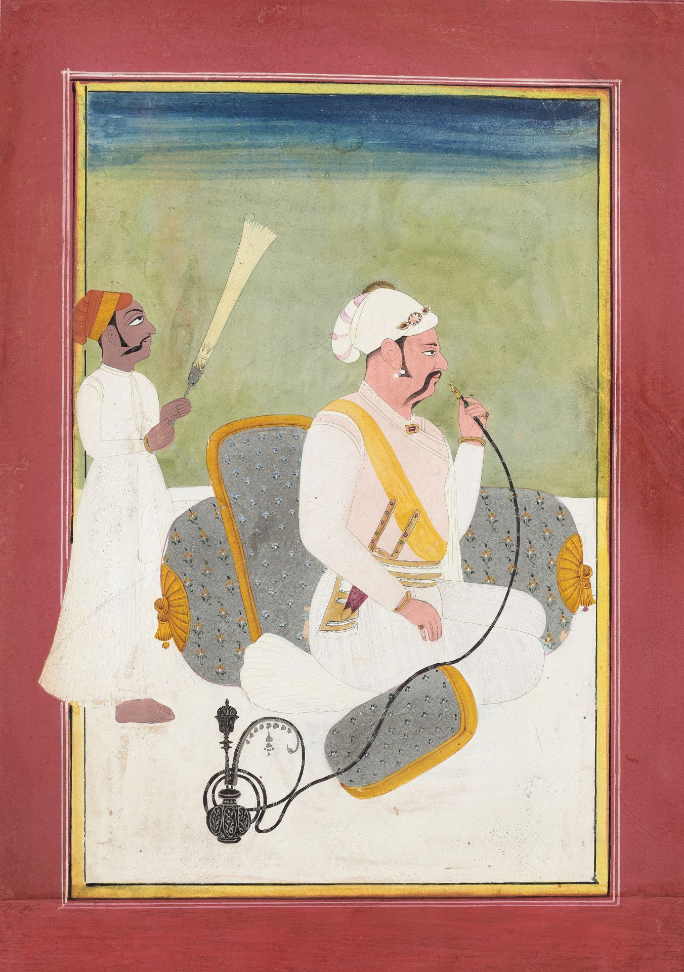 AN INDIAN MINIATURE PAINTING OF A MUGHAL PRINCE SMOKING A HUQQA