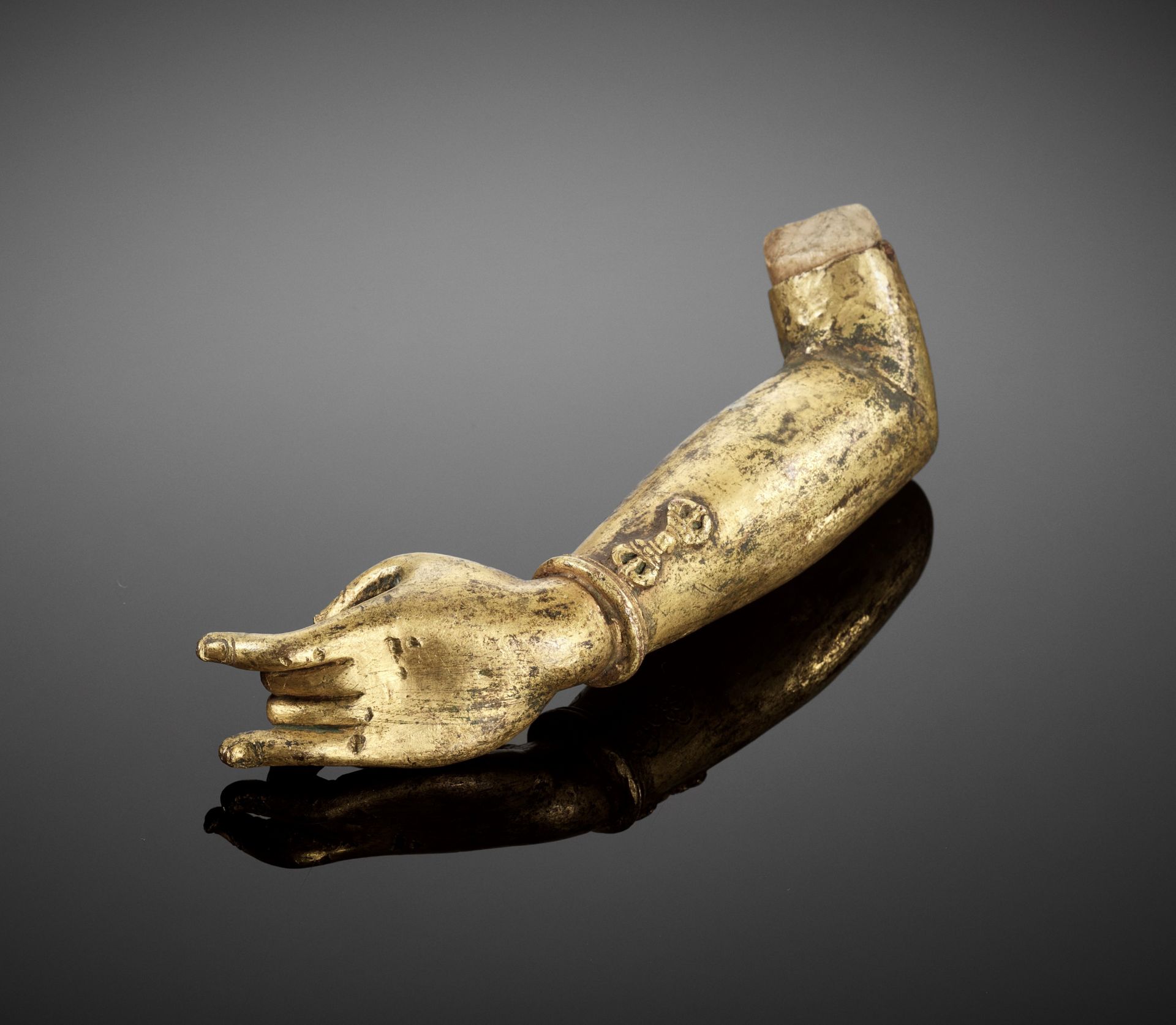 A GILT BRONZE 'KARANA MUDRA' FRAGMENTARY ARM, MING DYNASTY