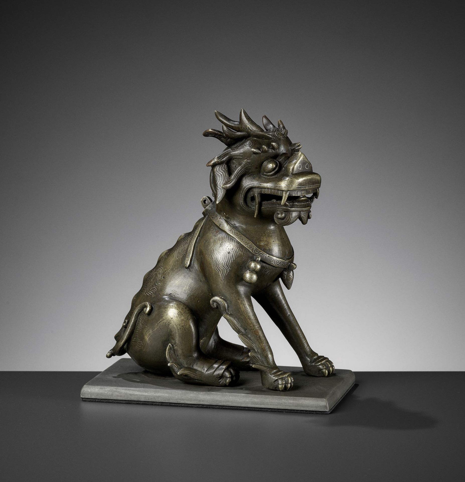 A SILVER WIRE-INLAID BRONZE FIGURE OF A QILIN, ATTRIBUTED TO SHISOU, QING DYNASTY
