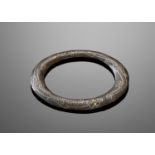 A SILVER AND GOLD INLAID BRONZE BANGLE, WARRING STATES TO WESTERN HAN