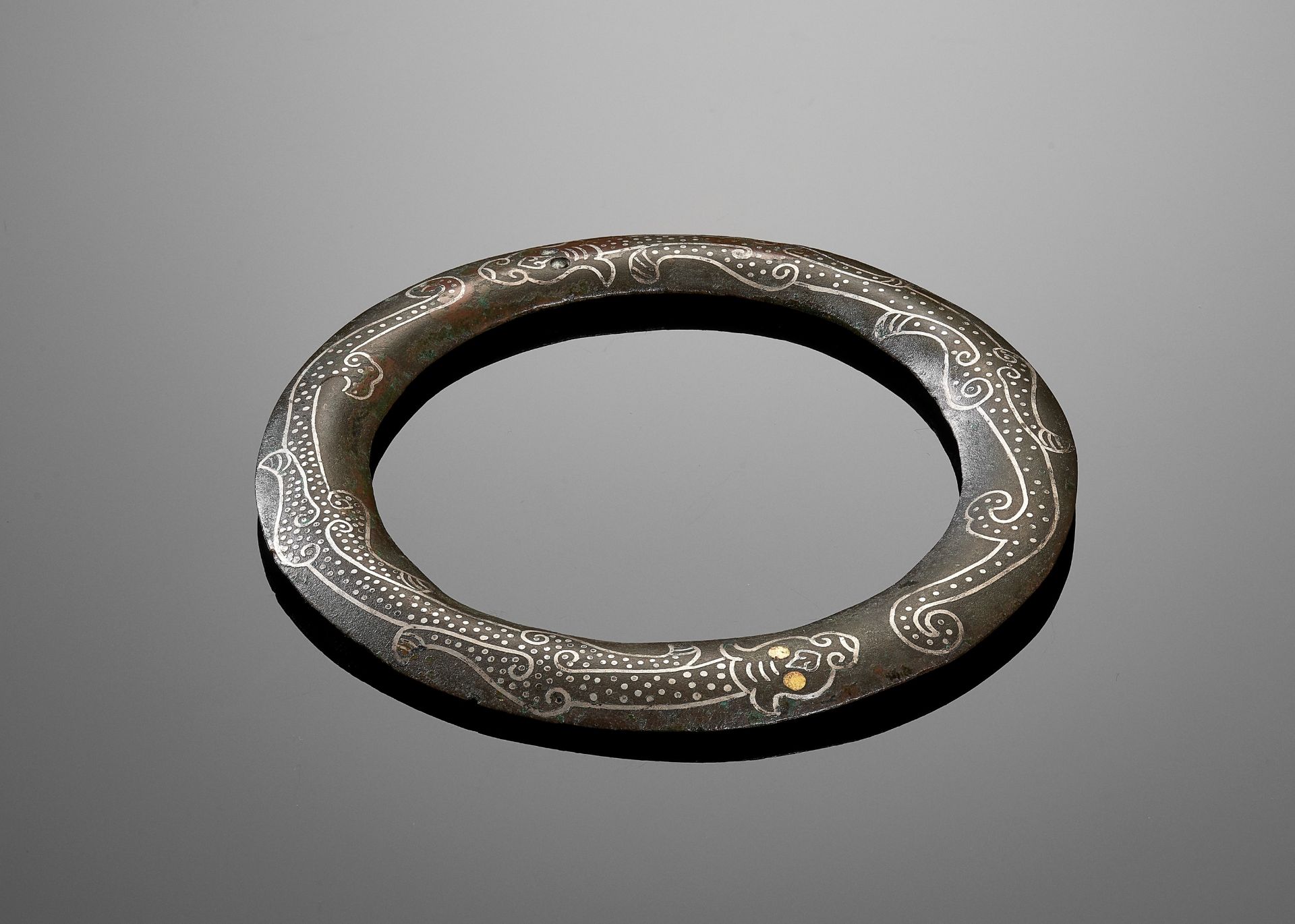 A SILVER AND GOLD INLAID BRONZE BANGLE, WARRING STATES TO WESTERN HAN